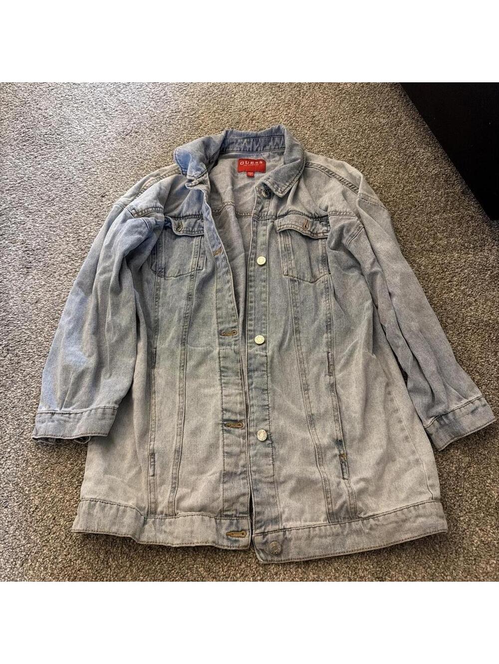 This is a light-wash denim jacket from GUESS
